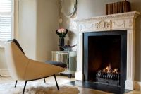 Modern armchair by period fireplace