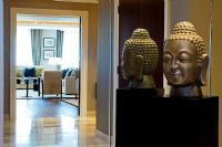 Modern hallway with Buddha sculpture reflected in mirror