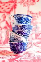 Stack of Spode willow patterned cups