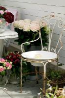 Vintage iron chair and flower arrangements