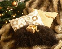 Fur rug and cushions by Christmas tree