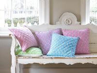 Wooden seat and colourful cushions 
