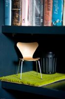 Miniature designer chair and carpet on shelf
