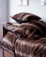 Brown fake fur blankets and cushions detail 