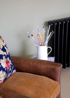 Vintage armchair and jug with knitting needles