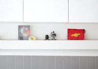 Childrens artwork and ornaments on kitchen shelf