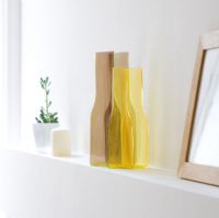 Colourful vase on white shelf