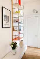 Colourful shelves in hallway