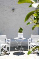 Garden furniture on paved terrace 