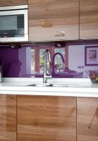 Modern kitchen sink with purple splash backs 