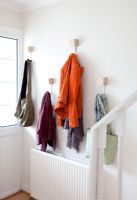 Coats hanging in modern hallway 