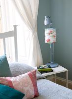 Floral lampshade on modern bedside table 