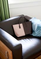 Handbag on modern leather armchair