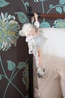 Detail of fairy hanging from bed frame
