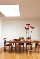 Modern dining room with poppy mural on wall