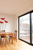 Modern dining room with poppy mural on wall
