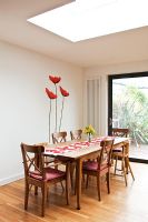 Modern dining room with poppy mural 