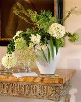 Classic vase of flowers on console table 