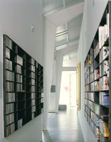 Bookcases on walls of modern corridor 