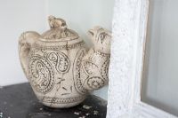Detail of decorative teapot on shelf 