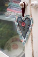Fabric heart hanging on door handle 