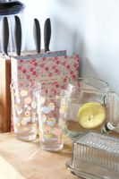 Glass jug of water on wooden worktop 
