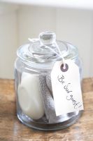 Glass jar containing soap and flannel