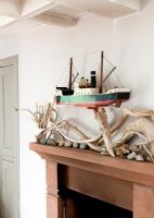 Wall mounted model ship over mantelpiece 