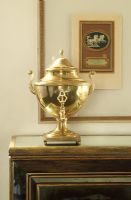 Detail of gold urn on sideboard 
