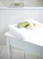 Towel and soaps in modern white bathroom  