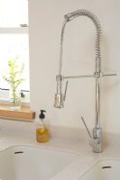 Detail of modern rinse tap in kitchen 