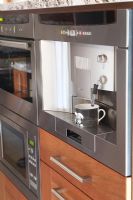 Built in coffee machine in modern kitchen 