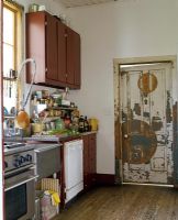 Modern kitchen with distressed wooden door 