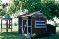 Exterior of wooden shed and garden seat