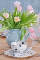 Detail of pink tulips on dining table 