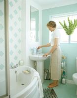 Woman using bathroom sink 