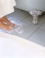 Womans feet on bathroom floor 
