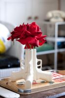 Gun shaped vase of flowers 