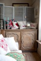 Patterned cushions on sideboard 
