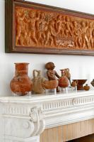 Display of ceramic items on mantelpiece 