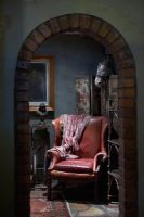 Vintage leather armchair through archway 