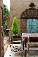 Table and chairs in courtyard garden 