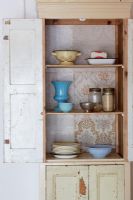 Kitchen utensils in storage cupboard 