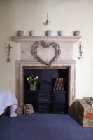 Heart shaped willow wreath over fireplace 