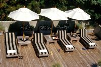 Sun loungers and parasols on decking 