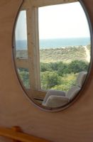 Oval mirror with reflection of sea view