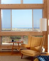 Modern armchair next to window with sea views 