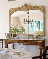 Gilded mirror in classic dining room 