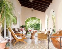 Classic garden furniture on covered terrace 