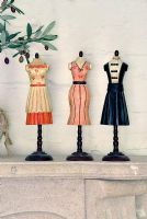 Miniature dressmakers dummies on mantelpiece 